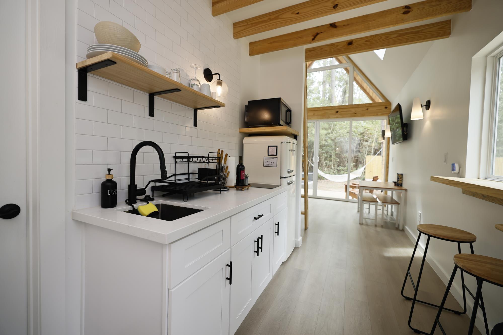 Cabin kitchen with exposed beams and A-frame windows