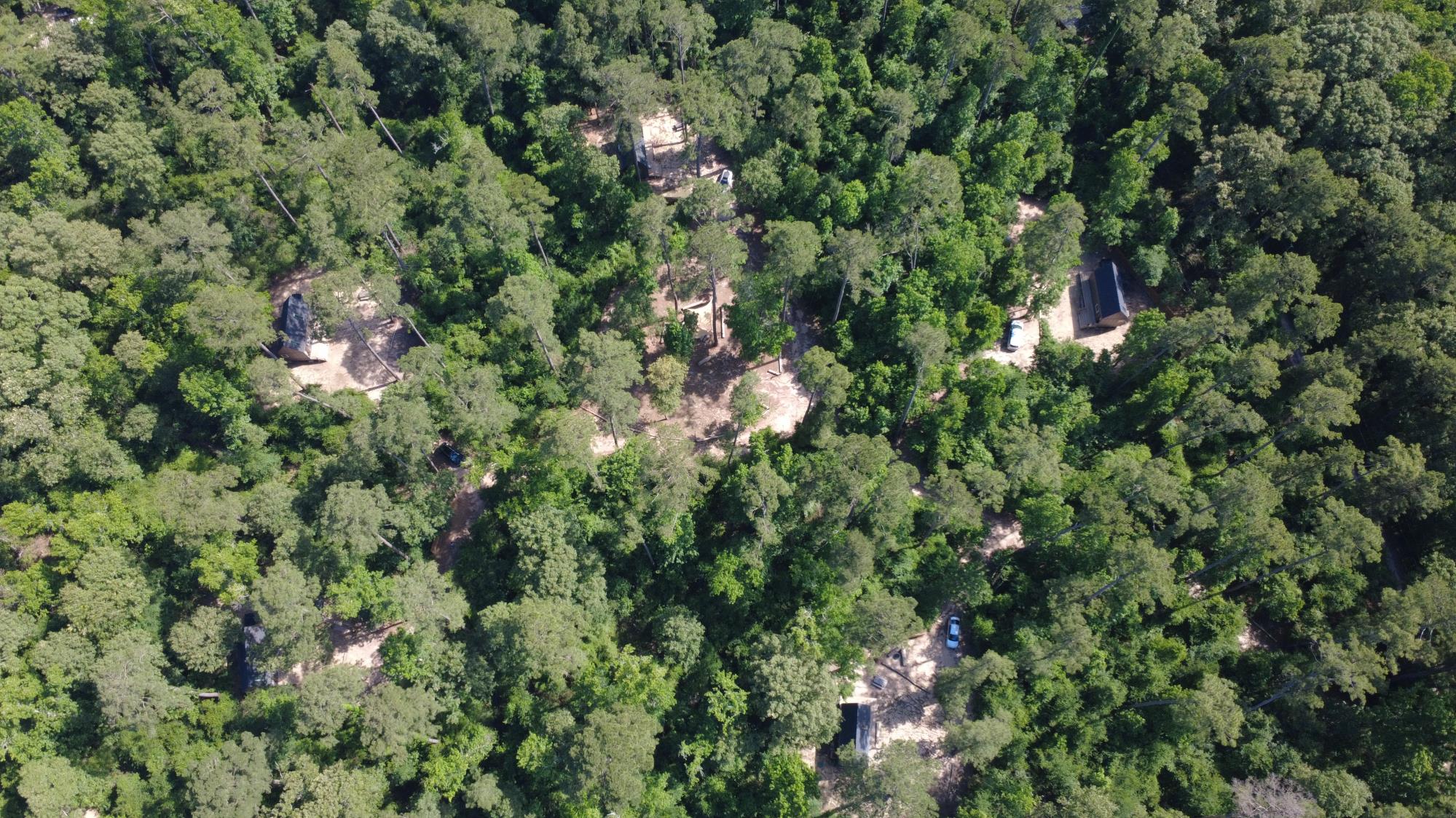 Aerial view of all five cabins in the forest